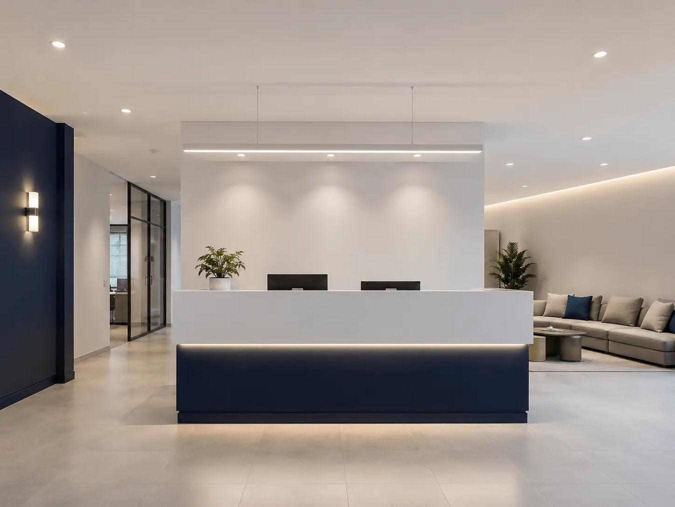 Modern office reception area with a white desk, chairs, and decorative elements.