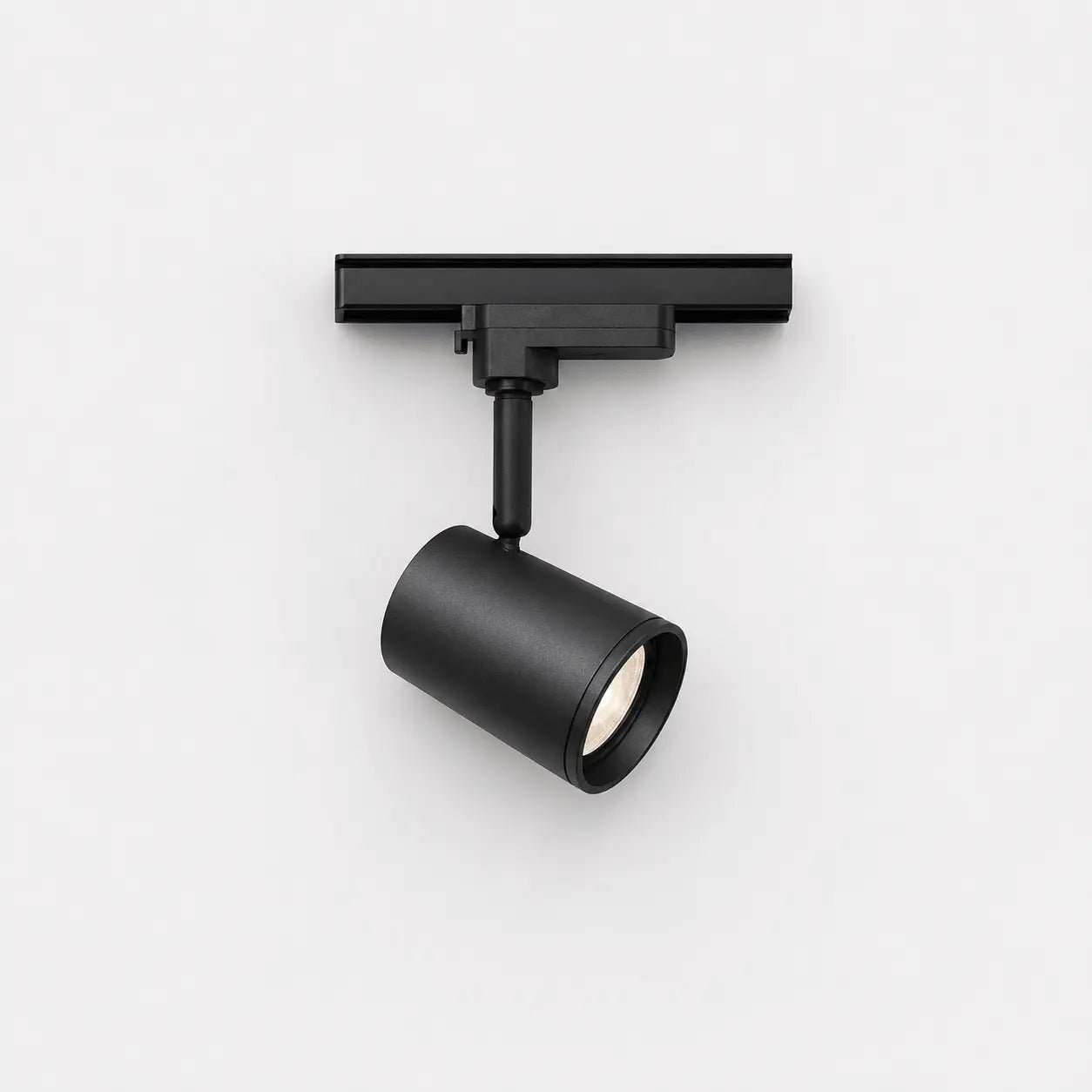Black track light fixture on a white background